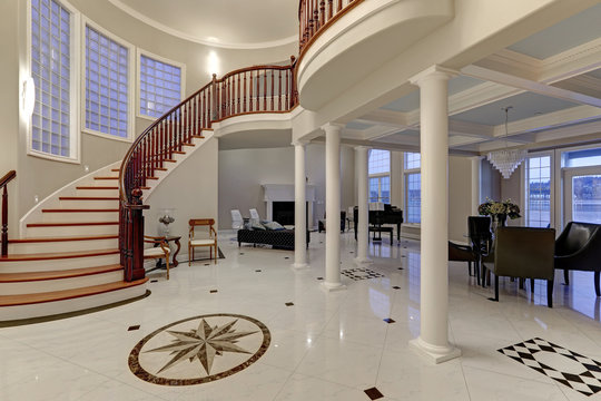 Stunning two story entry foyer with marble mosaic tiled floor