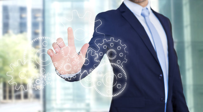 Businessman touching technology interface with gear wheel settin