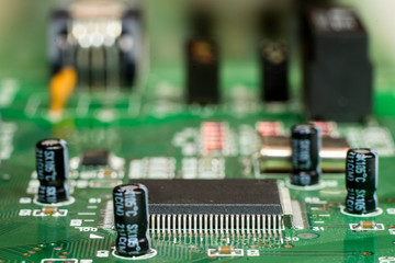 Close up of printed electronic circuit board with microcontroller and components;