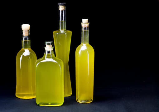 four bottles of sorrento limoncello,  horizontal black background