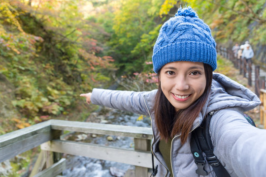 Woman taking selfie when hiking in forest