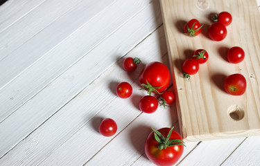 Fototapeta na wymiar harvest fresh tomato top on wooden background