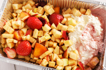 Healthy food in foil box, diet concept. Cheesecake dessert