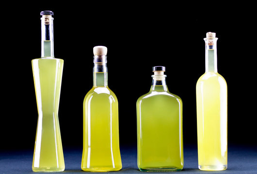 four bottles of  Sorrento limoncello, dark background