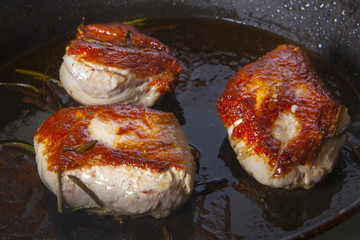 pork with rosemary fried in a pan