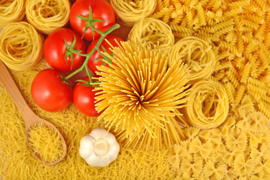 Italian pasta, ripe tomatoes branch and garlic