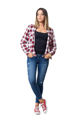 Young casual woman with hands in pockets wearing plaid red and white shirt and jeans. Full body length portrait isolated over white studio background.