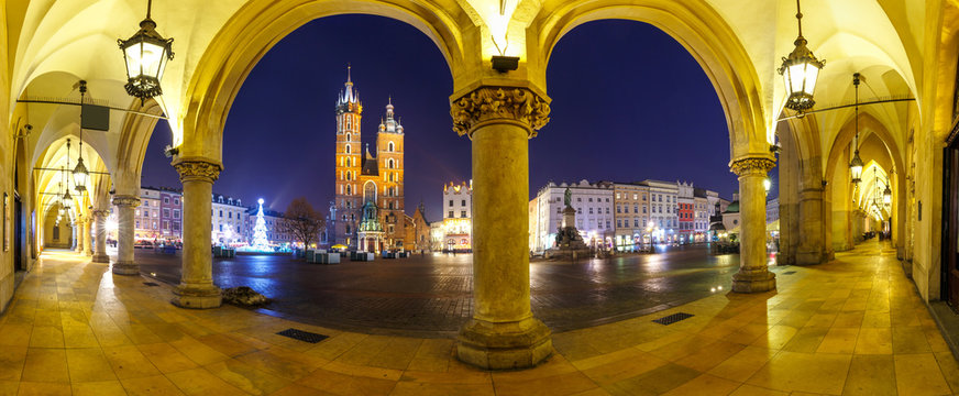 Panoramic view of Sukiennice and St. Mary's Church at night in Krakow, Poland