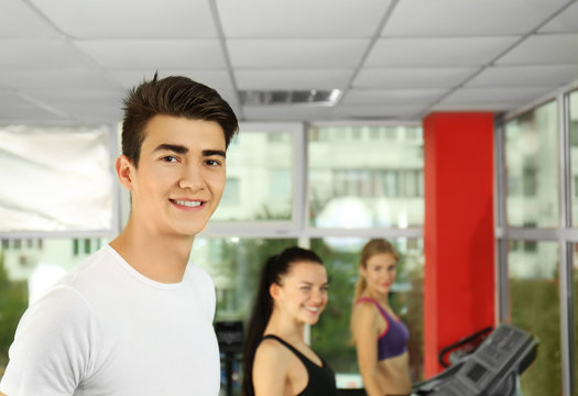 Portrait of handsome young man in gym