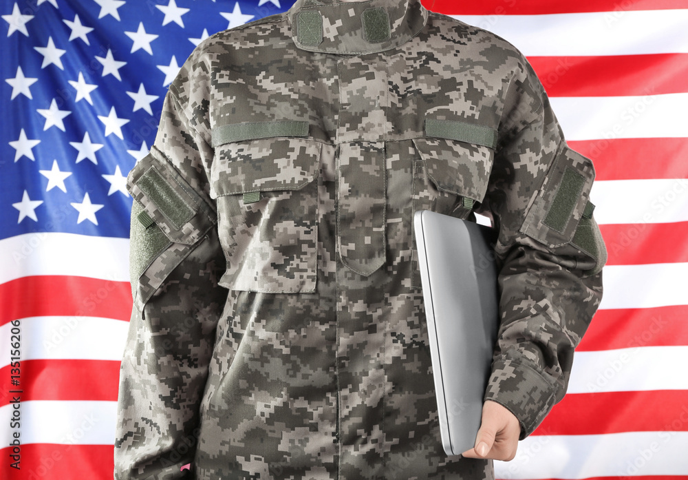 Wall mural Soldier holding laptop. Military education concept