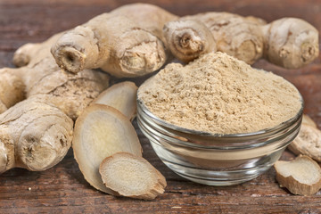 Ginger with ginger spice on wooden table