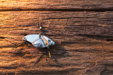 Fishing hook on wood background