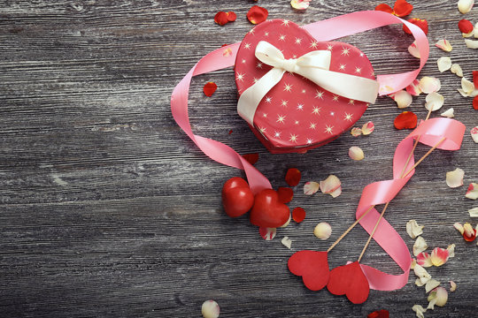St. Valentines Day concept. Gift box and decorations on wooden table