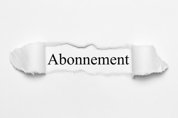 Abonnement on white torn paper