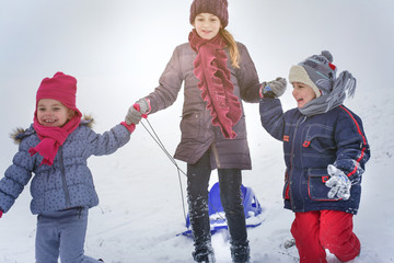 Happy children playing in snow.