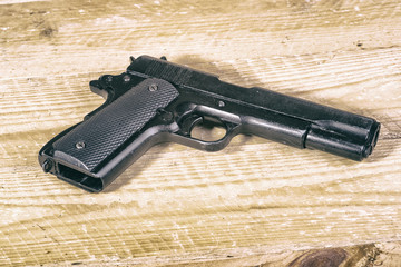 solitary gun  on wooden background