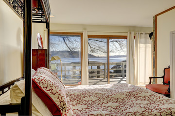 Sun filled bedroom boasts king size canopy bed