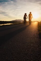 Papier Peint photo autocollant Vélo Two cyclists are on sunset road