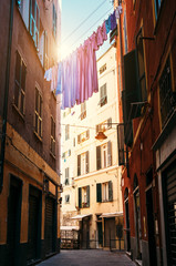 Fototapeta na wymiar Colorful linen drying between houses in old italian street