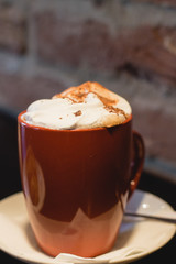 Coffe with whiped cream for breakfast with croissant in cafe