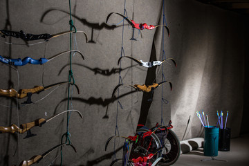 Bows and arrows in an indoor archery range - archery club