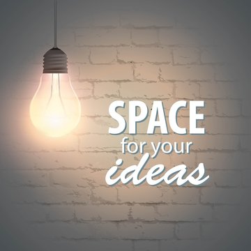 Glowing lamp on a brick wall background with space for your text