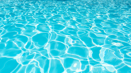 Blue and bright water surface and ripple wave in swimming pool