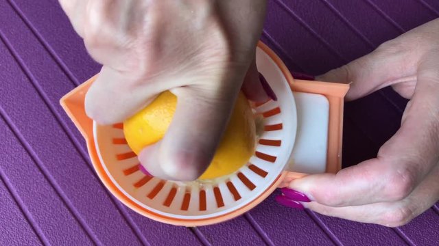 Close-up citrus juicer manual use for healthy vitamin C drink 3840X2160 UltraHD footage - Lemonade extractor used by pedicured female 4K 2160p 30fps UHD video