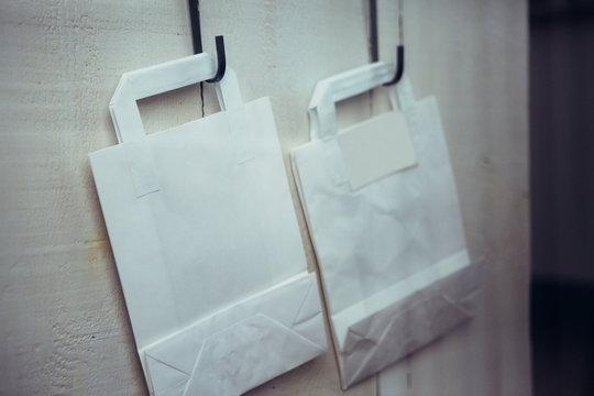 Two paper bags on wall