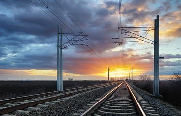 Fototapeta premium Railroad tracks in the setting sun