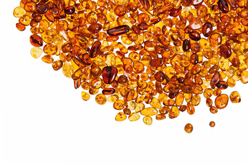 Dark yellow amber stones on a white background.