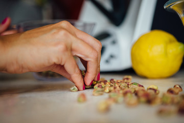 Woman taking peeled pistachio