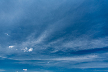 Beautiful vast sky deep blue color with white spindrift clouds at sunny summer day
