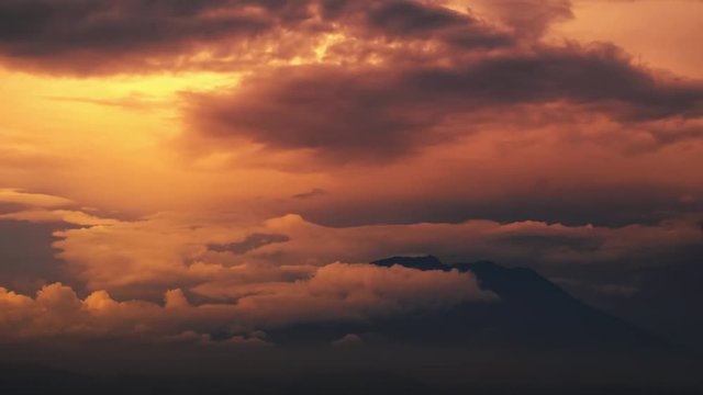 Time lapse of the sunset with clouds over volcano of Agung, Bali, Indonesia