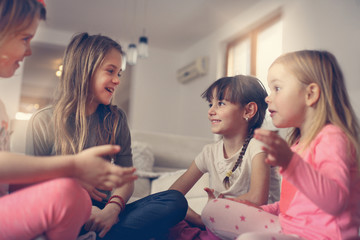 Four girls sitting on the floor.