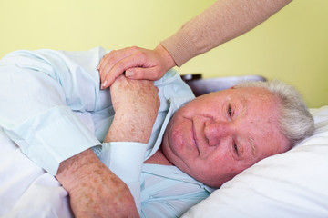 Depressed old man in bed