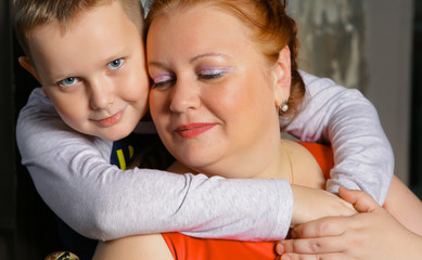 Happy boy hugging his mother