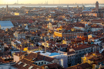 Fototapeta premium Panoramic aerial cityscape of Venice,with rooftops, the sea at sunset, Veneto, Italy.