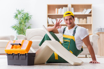 Worker repairing furniture at home