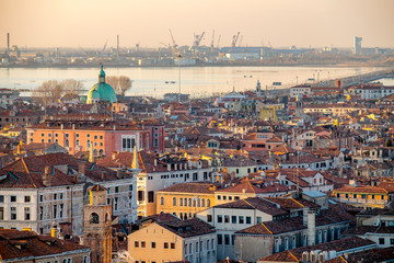 Obraz premium Panoramic aerial cityscape of Venice,with rooftops, the sea at sunset, Veneto, Italy.