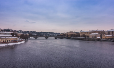 Fototapeta na wymiar View of Prague and Vtlava river under the snow