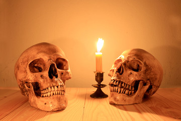 human skull with light candle in night time, still light photography.