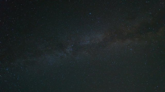 The starry sky with milky way on the background of meteor shower. Time lapse