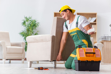 Worker repairing furniture at home