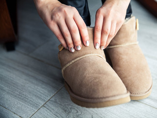 The girl with a nice manicure gray dress ugg boots. Shoes, fashion, style, modern - 135164429