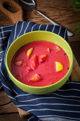 Vegetarian red soup - borsch in green bowl.