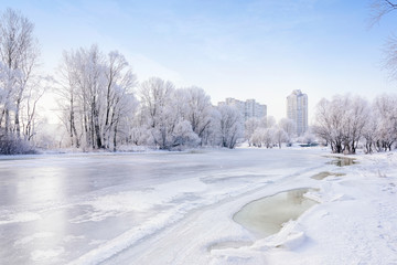 Landscape with trees, frozen water, ice and snow on the Dnieper river in Kiev, Ukraine, during...