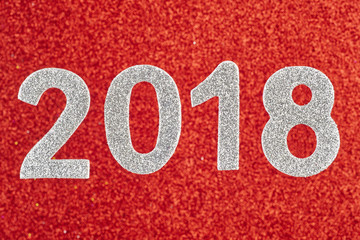 Number two thousand eighteen white over a red background. Annive