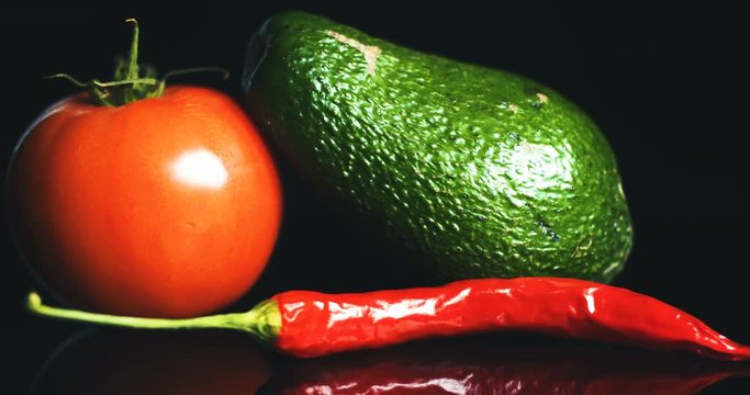 cloase up shoot of tomato, hot pepper and guacamole