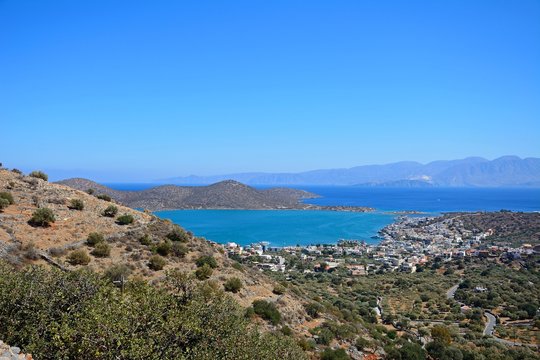 Elevated view of Elounda with views across the sea towards the island of Spinalonga, Elounda, Crete.